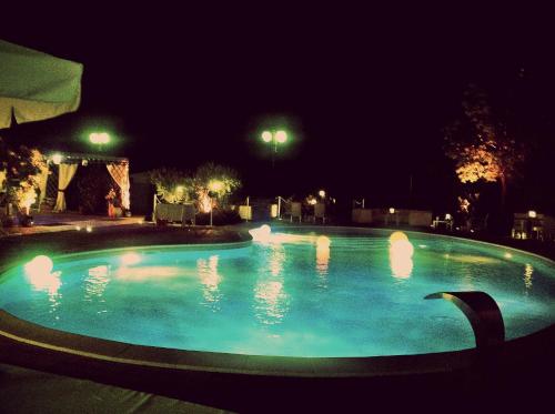 a large swimming pool at night with lights at Do Ciacole In Relais in Mira