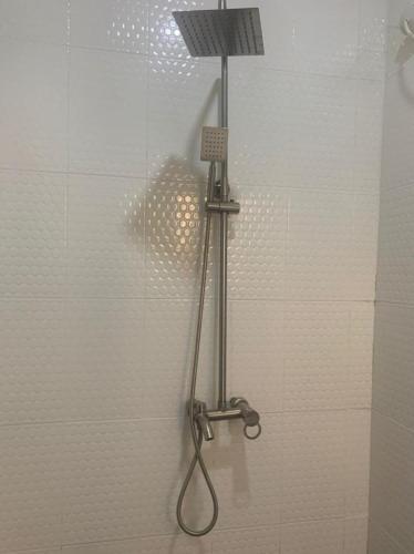 a shower with a shower head in a bathroom at Modern Bungalow in Idi Aba in Abeokuta