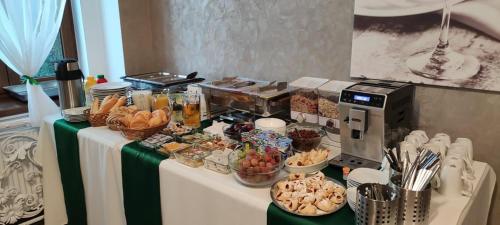 a table with a buffet of food on it at Hotel MERTIN in Chomutov