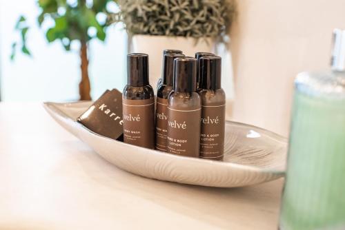 three bottles oficating oils in a bowl on a table at Errigal Country House Hotel in Cootehill