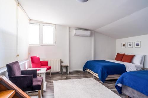 a bedroom with two beds and two chairs at Gorgeous Flat with Balcony in Besiktas in Istanbul