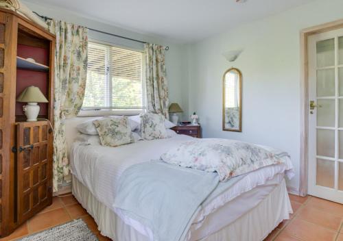 a bedroom with a large white bed in a room at Blackthorn Barn in Goudhurst