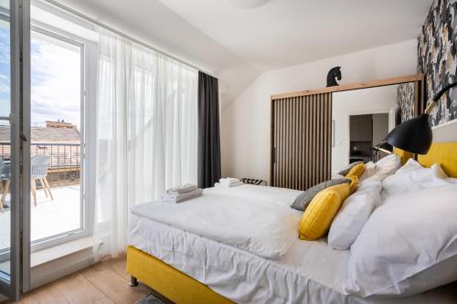 a bedroom with a large bed and a large window at Rose Garden Residence - Boutique Apartments in City Center in Budapest