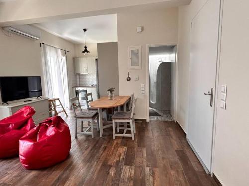 a kitchen and dining room with a table and chairs at Santa's Luxury Apartment in Tinos