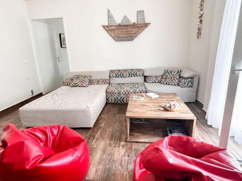 a living room with a couch and a table at Santa's Luxury Apartment in Tinos