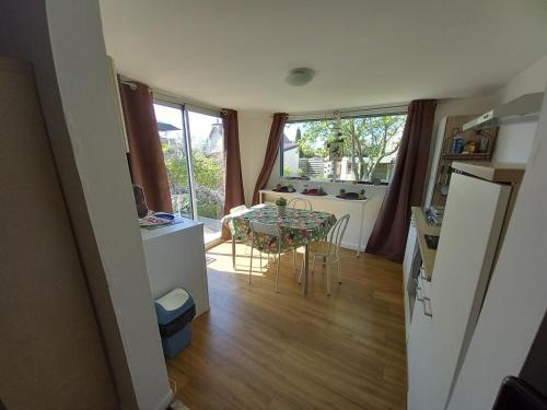 a kitchen and a dining room with a table at un îlot de calme in Morlaix