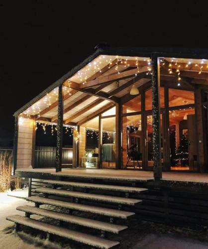 a building with lights on it at night at Romantic Getaway for 2 with Wellness / Bohemian Homes in Studánka
