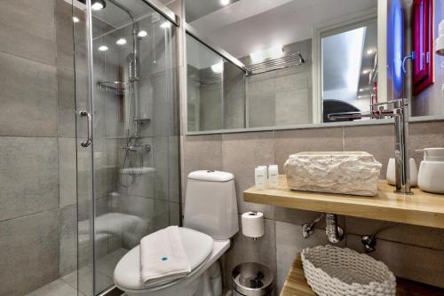 a bathroom with a toilet and a glass shower at Katerina mare in Naousa