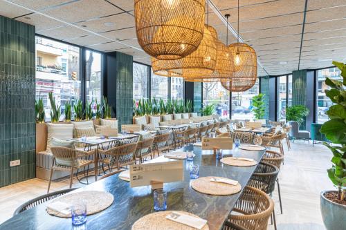 a restaurant with tables and chairs and large windows at JS Palma Plaza in Palma de Mallorca