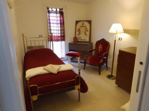 a bedroom with a bed and a dresser and a chair at Roomsfree!!!! in Ariano Irpino
