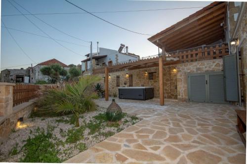 a house with a patio with a garage at Pamelas House with Jacuzzi in Kissamos