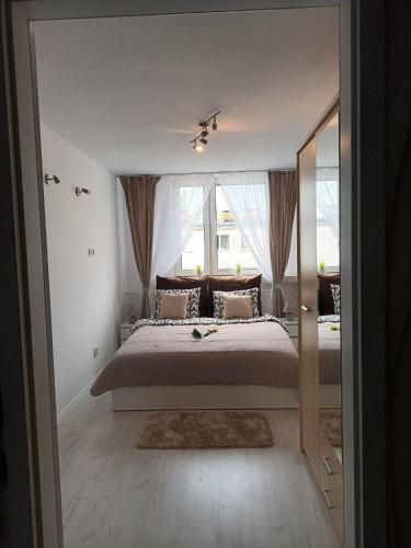 a bedroom with a bed and a large window at Apartament u Ani in Wrocław