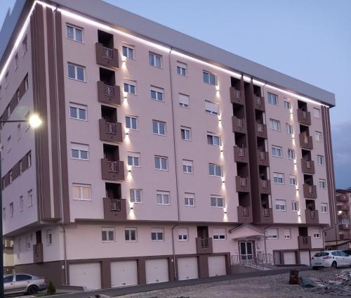 a large apartment building with lights on it at Apartman IRIS in Bijeljina