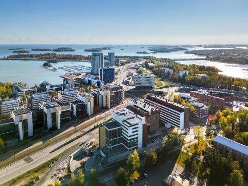 an aerial view of a city with a river and buildings at Heymo 1 by Sokos Hotels in Espoo