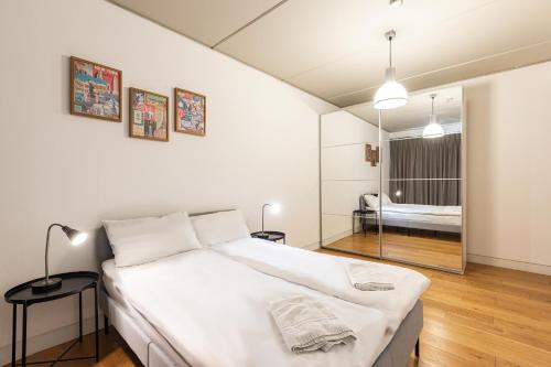 a bedroom with a large white bed in a room at Shoreditch London Apartments in London