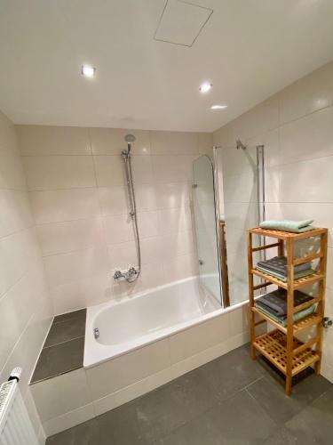 a bathroom with a bath tub and a shower at Appartement Two in Ötztal-Bahnhof