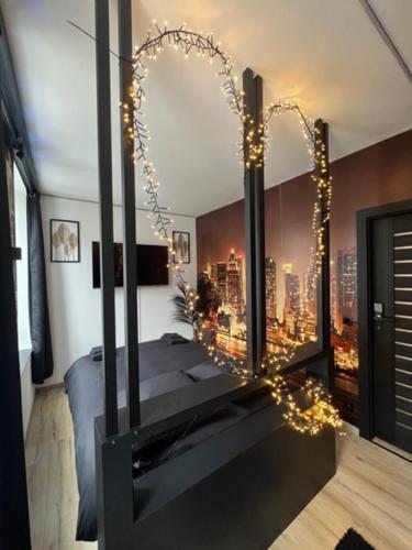 a bedroom with a bed with a view of a city at Aux trois univers in Verviers