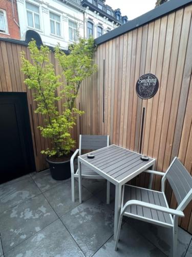 a table and two chairs sitting on a patio at Aux trois univers in Verviers