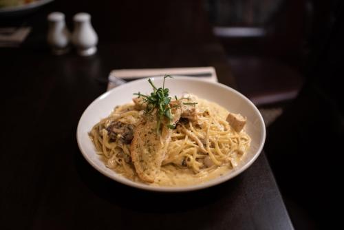a bowl of pasta with shrimp on a table at Errigal Country House Hotel in Cootehill