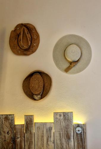 a group of hats hanging on a wall at Podere Bellavista in San Gimignano