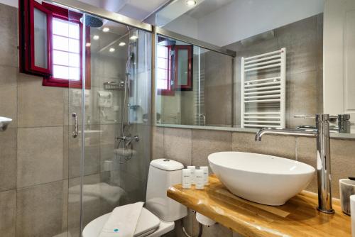 a bathroom with a sink and a toilet and a shower at Katerina mare in Naousa