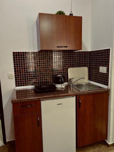 a kitchen with a sink and a counter top at Old Town - Guest House in Stari Bar