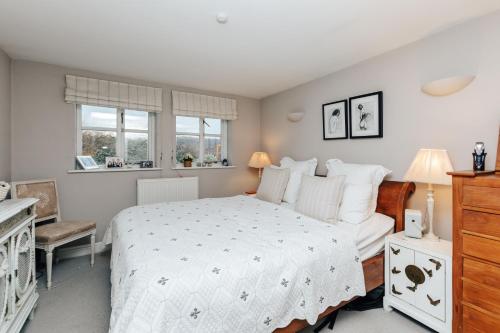 una camera con un letto bianco e due finestre di Soho House - 4 Bedrooms, Central Henley a Henley on Thames