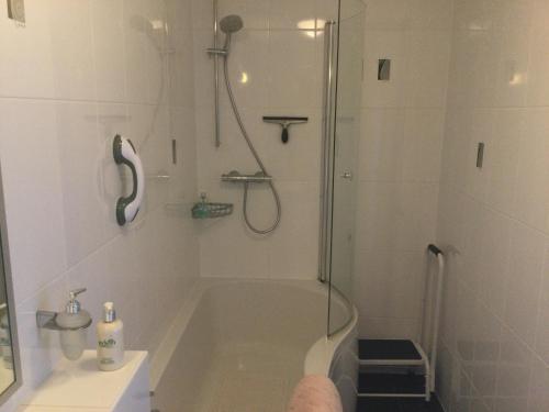 a bathroom with a shower and a bath tub at HH Accommodation in Millom