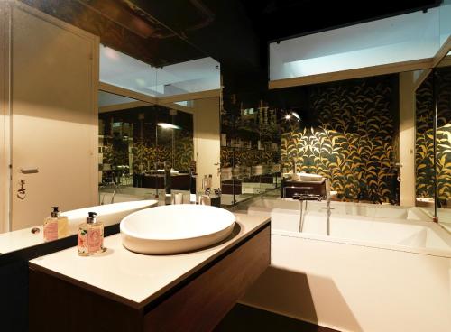 a bathroom with a sink and a tub and a toilet at Villa Ella in Luxury Resort in Gardone Riviera