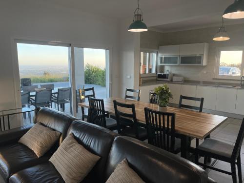 a living room with a couch and a table and chairs at Luar do Algarve in Monchique
