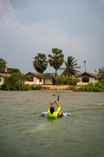 a person is on a raft in the water at MKS - Kite & Wing Foil camp in Kalpitiya