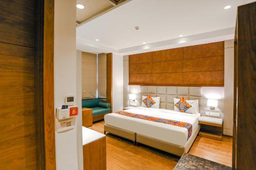 a hotel room with a bed and a couch at FabHotel Hexa Chhatarpur in New Delhi