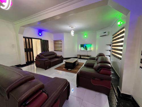 a large living room with couches and a tv at CampDavid Luxury Apartments Ajao Estate Airport Road Lagos 0 8 1 4 0 0 1 3 1 2 5 in Lagos