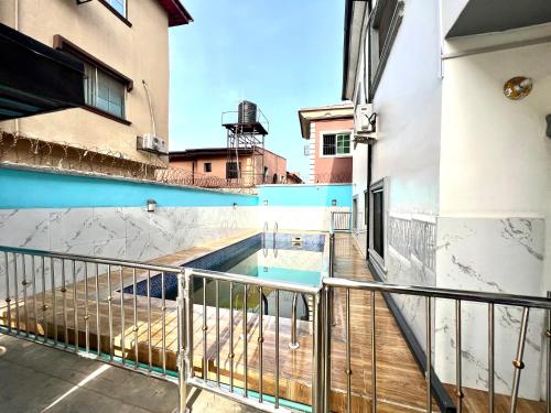 a balcony with a swimming pool in a building at CampDavid Luxury Apartments Ajao Estate Airport Road Lagos 0 8 1 4 0 0 1 3 1 2 5 in Lagos