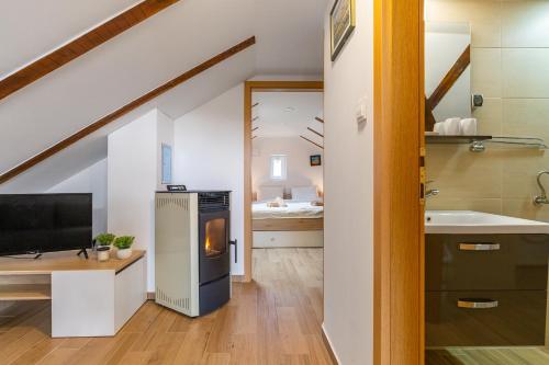 a kitchen with a sink and a stove at SOKOL - Secret forest house in Gračac