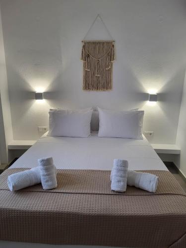 a bedroom with a bed with two towels on it at Stavros Residence in Mármara