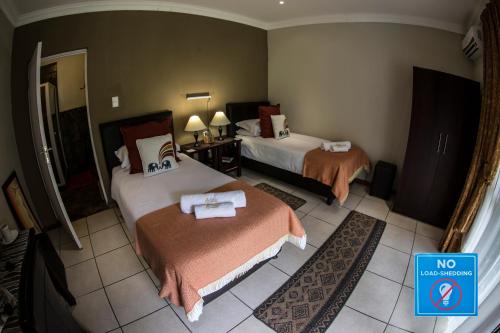 Ένα ή περισσότερα κρεβάτια σε δωμάτιο στο Arista Guesthouse