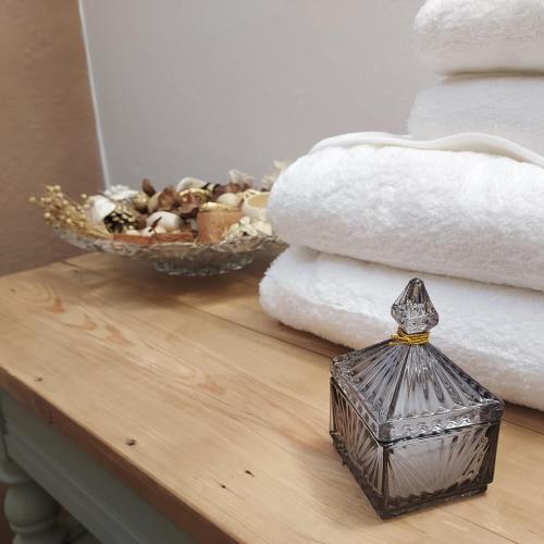 a table with towels and a basket of towels at Les Pierres de Cézaire in Saint-Cézaire-sur-Siagne
