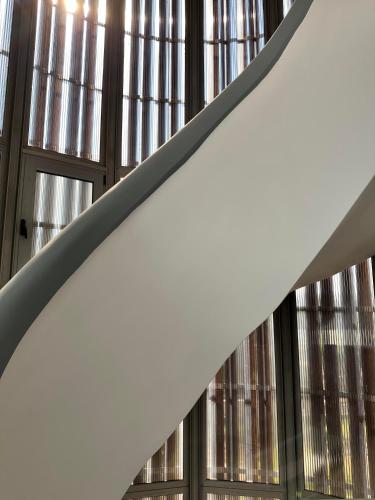 a staircase in a building with windows at EVa's Luxury Apartments No 1 in Áyios Spirídhon