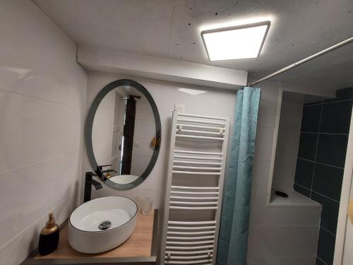 a bathroom with a sink and a mirror at Les Pierres de Cézaire in Saint-Cézaire-sur-Siagne