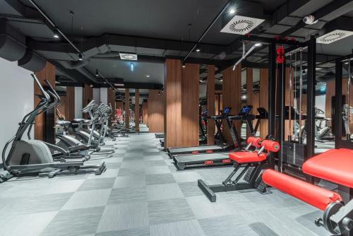 a gym with a row of treadmills and machines at Jungle Valley, Nadmotławie, Old Town in Gdańsk