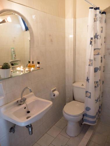 a bathroom with a sink and a toilet at Leader in Mytikas