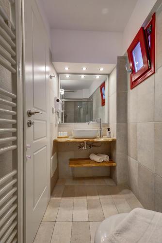 a bathroom with a sink and a toilet and a mirror at Katerina mare in Naousa