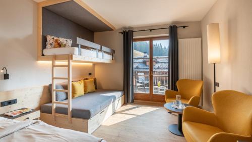 a bedroom with a bunk bed and a living room at Familienalm Taser in Schenna