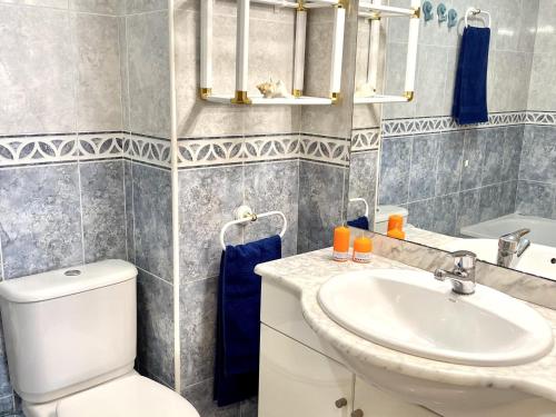 a bathroom with a white toilet and a sink at APARTBEACH LARIMAR MUY LUMINOSO y CLIMATIZADO in Salou