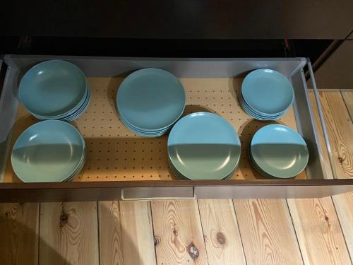 a group of blue dishes in a glass box at Haus mit wunderschönem Garten in Bad Freienwalde