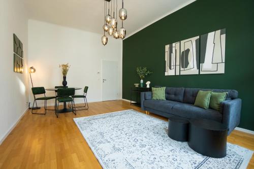 a living room with a blue couch and a table at Brand-new apartment with a breathtaking design located right near Belvedere Castle, 15 minutes from city centre in Vienna