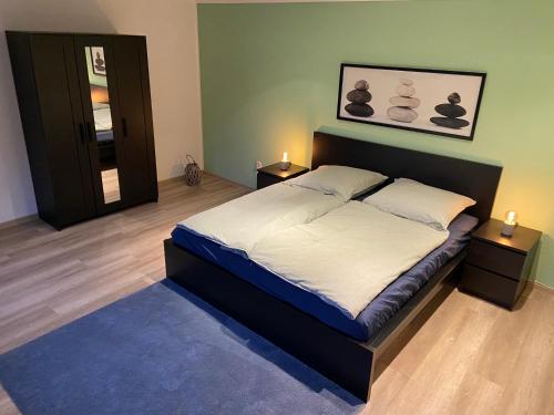 a bedroom with a large bed with two night stands at Haus mit wunderschönem Garten in Bad Freienwalde