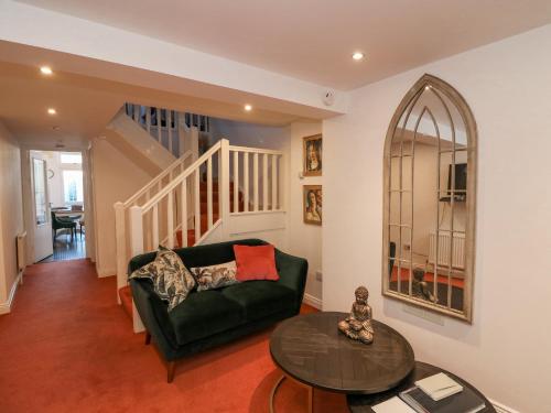 a living room with a green couch and a table at 83 Upper John Street in Wexford