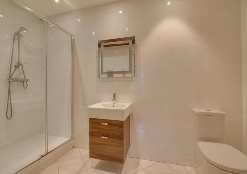 a bathroom with a sink and a shower and a toilet at Beachside Hideaway in Broadstairs